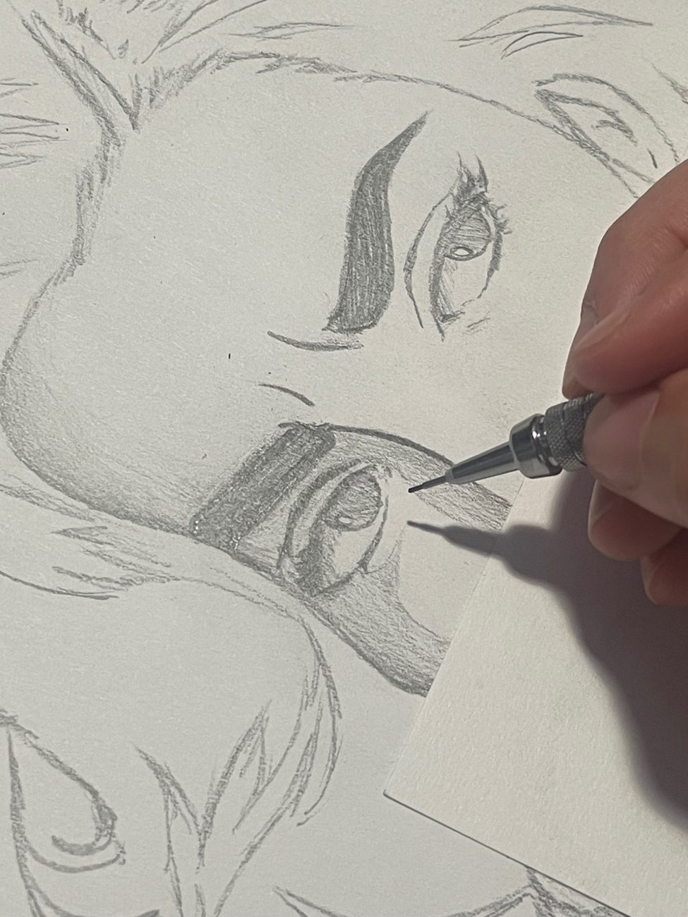 Mateo's hand drawing a portrait in pencil